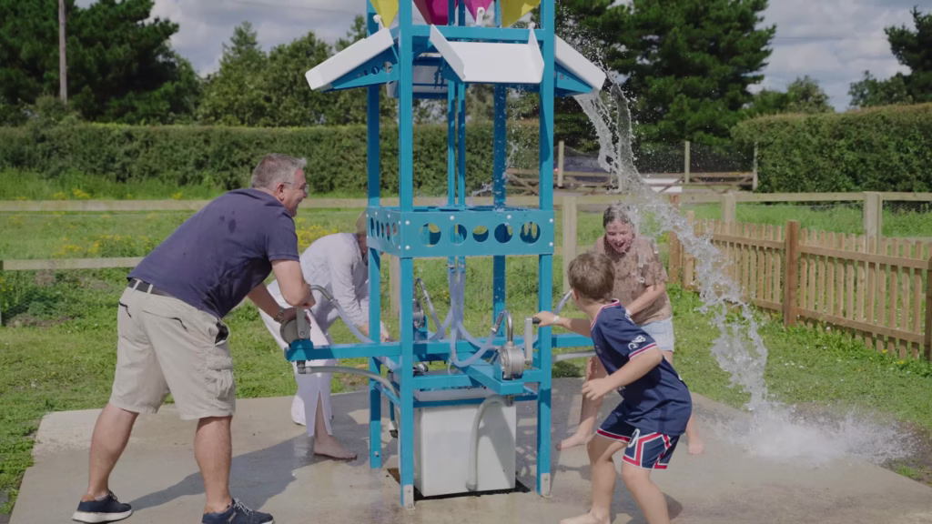 Family enjoying the water play activity at Southwold Maize Maze