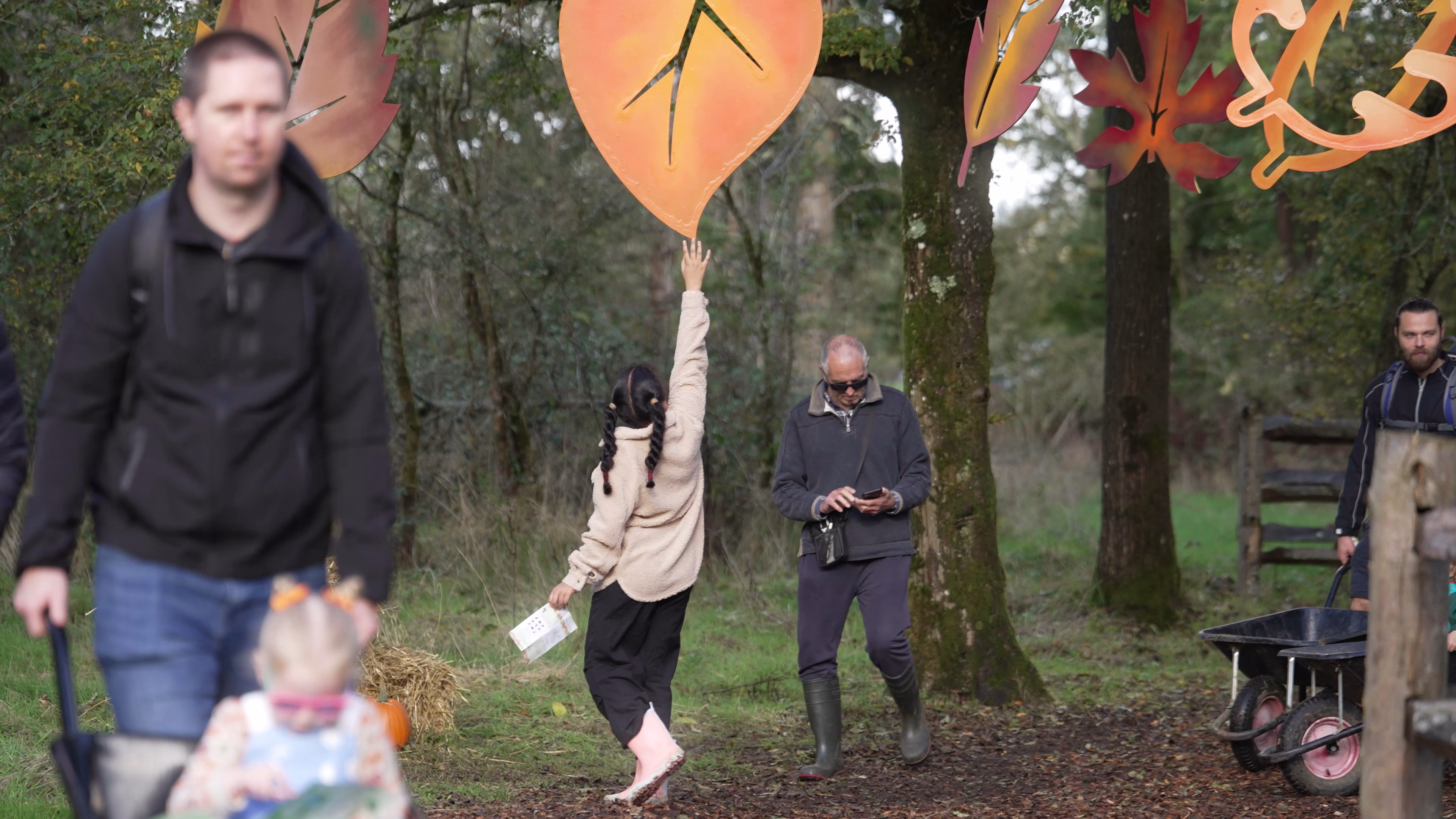Families following the decorated woodland trail at Wasing Pumpkin Patch